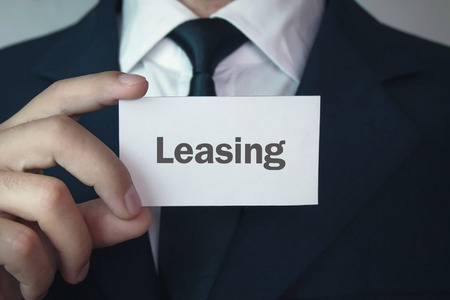 Man showing word leasing on the business card.の写真素材