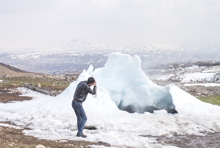 Man taking photo of ice.の写真素材