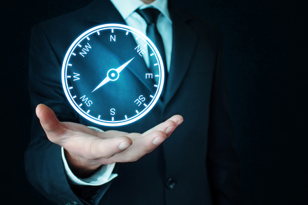 Man holding a compass.の写真素材