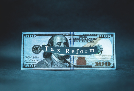 Tax Reform word in a torn hundred dollar.の写真素材