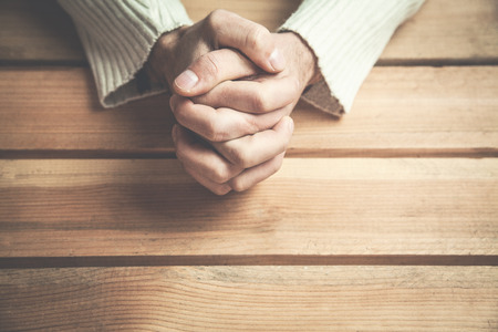 Praying hands on a wood background.の写真素材