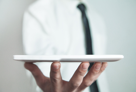 Businessman showing white digital tablet.の写真素材