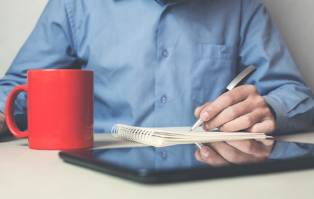 Man writing on notepad.の写真素材
