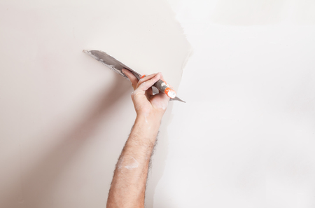 Plastering a wall with spatula.の写真素材