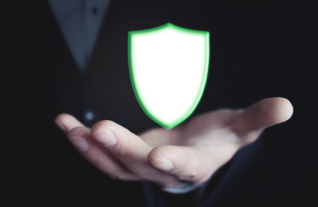 Man hand with shield security sign.の写真素材