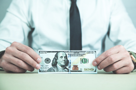 Caucasian businessman showing money in his desk.の写真素材