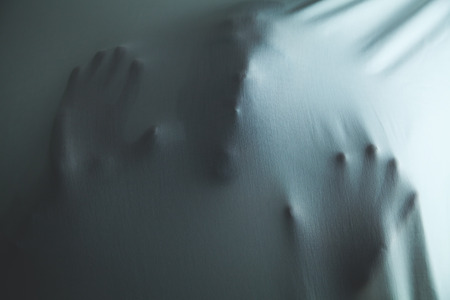 Screaming ghost face with hands. Scary and death conceptの写真素材