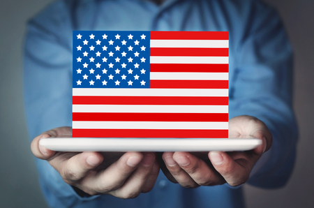 Businessman holding national flag of USA.の写真素材