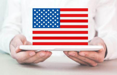 Businessman holding national flag of USA.の写真素材