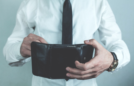 Businessman holding black leather wallet.の写真素材