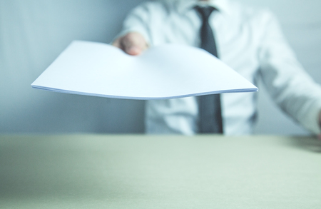 Businessman holding agreement documents in his desk. Business conceptの写真素材