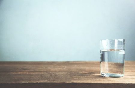 A glass of water on wooden table.の写真素材
