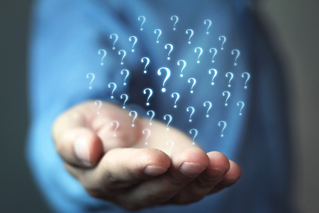 Man holding question marks. Business conceptの写真素材