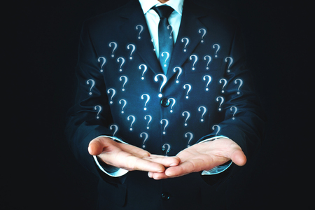 Man holding question marks. Business conceptの写真素材