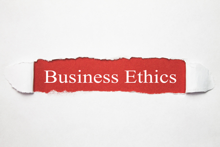 Business Ethics words on torn paper.の写真素材