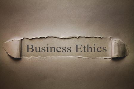 Business Ethics words on torn paper.の写真素材