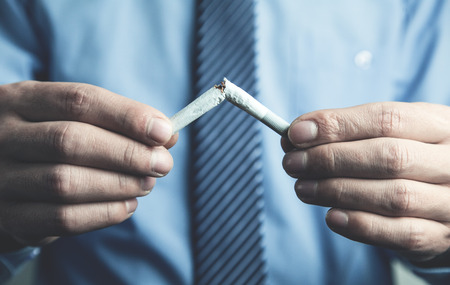 Man breaking a cigarette. Stop smokingの写真素材