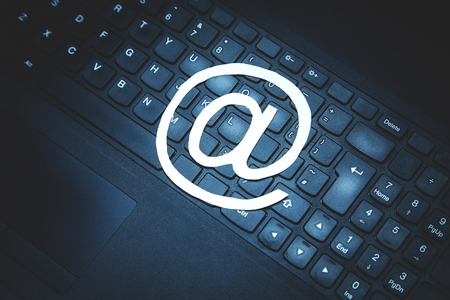 Paper email symbol on black laptop keyboard.の写真素材