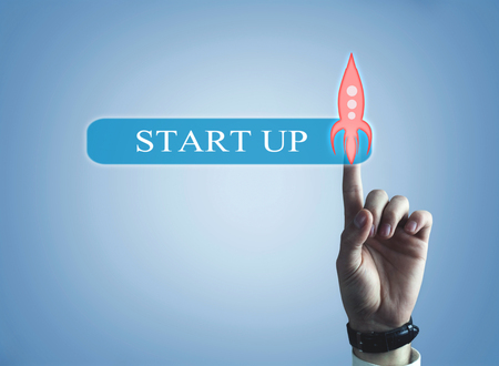 Hand touching transparent rocket icon. Startup concept