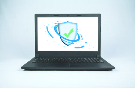 Shield security sign on a black laptop screen. Security conceptの写真素材