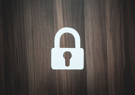 Paper padlock on wood background. Security conceptの写真素材
