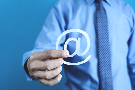 Businessman showing paper email symbol.の写真素材