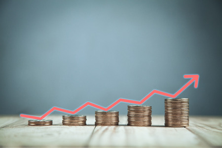 Golden coins with a red arrow. Financial success conceptの写真素材