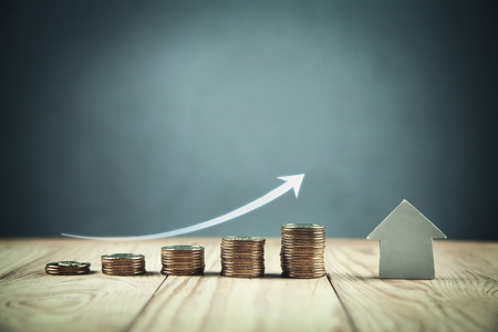 Coins with paper house. Investment mortgage conceptの写真素材
