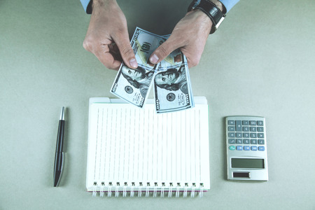 Businessman showing and counting dollars. Financial conceptの写真素材