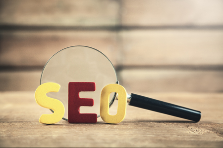 Colorful word Seo with magnifying glass. Search engine optimisation conceptの写真素材