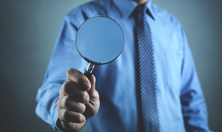 Man holding magnifying glass. Search and solutionの写真素材