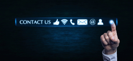 Hand pressing contact us buttons. Customer support conceptの写真素材