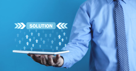 Man holding arrows with Solution button. Business conceptの写真素材