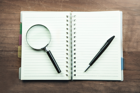 Magnifying glass and pen on notepad. Business conceptの写真素材