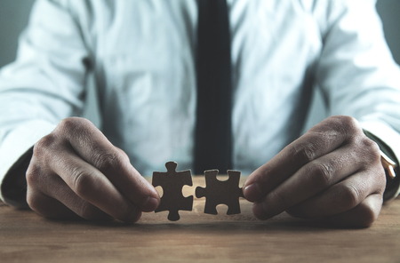Businessman showing puzzles. Business solution conceptの写真素材