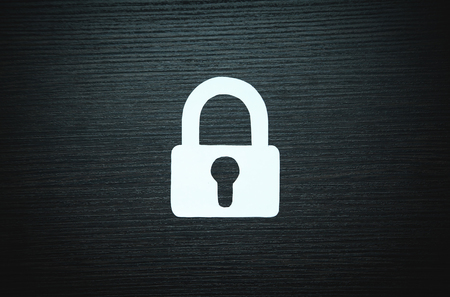 Paper padlock on black wood background. Security conceptの写真素材