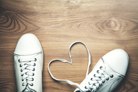 White sneakers on a wooden background.の写真素材