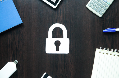 Paper padlock and other items on a wood background. Security conceptの写真素材