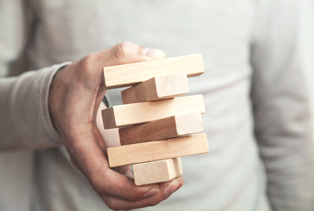 Caucasian man holding blank wooden blocks.の写真素材