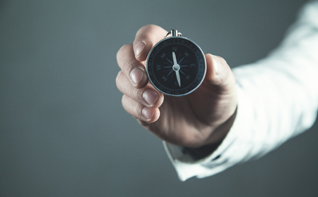 Man showing compass. Business conceptの写真素材