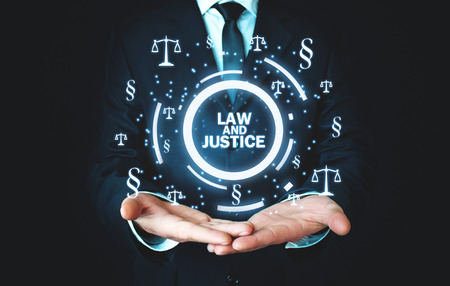 Man holding Justice Scales and Paragraph symbols. Law and Justice conceptの写真素材
