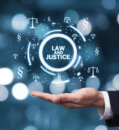 Hand holding Justice Scales and Paragraph symbols. Law and Justice conceptの写真素材