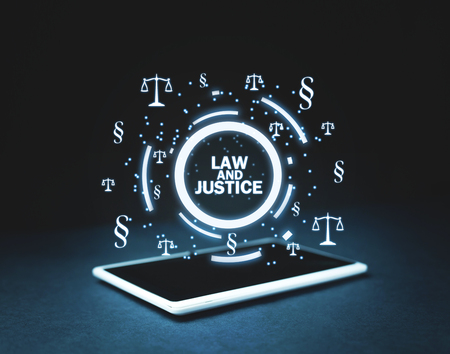 Justice Scales and Paragraph symbols on tablet. Law and Justice conceptの写真素材