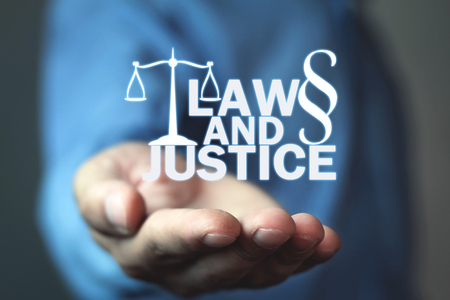Man holding Law and Justice words with Scales and Paragraph symbol.の写真素材