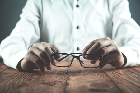 Businessman showing glasses in his desk. Business conceptの写真素材