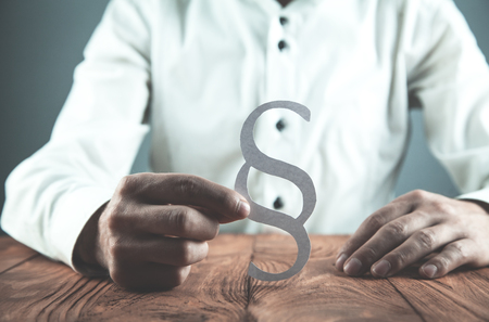 Businessman holding paper Paragraph symbol.の写真素材
