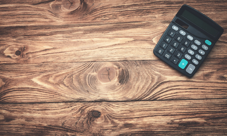 Black calculator on wooden desk. Business conceptの写真素材