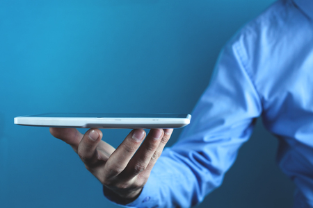 Businessman holding white digital tablet. Concept of new technologyの写真素材