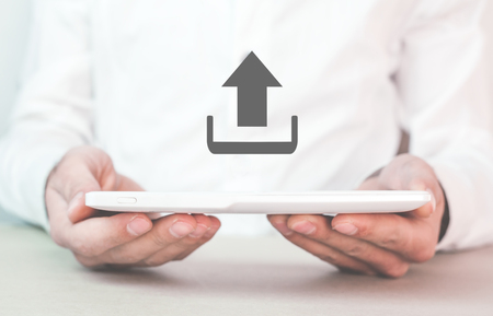 Man holding tablet with web upload icon.の写真素材