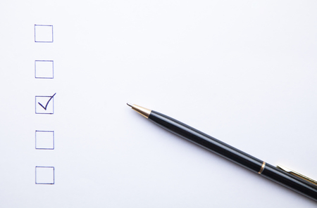 Pen and Checklist on white paper. Business conceptの写真素材